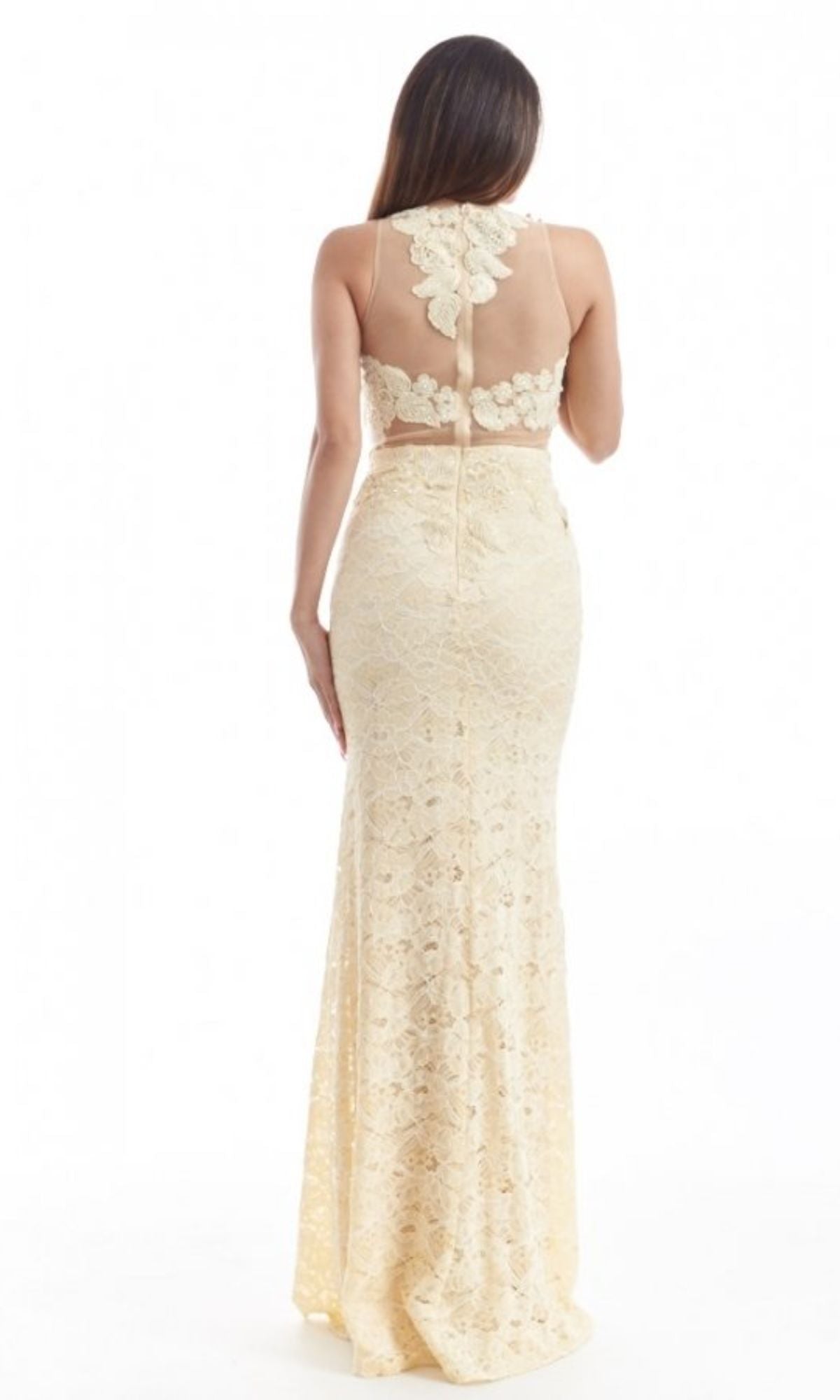 Woman with her back to the camera wears the Mock Two-Piece Long Lace Prom Dress: Chicas CR4225, a sleeveless light yellow mermaid gown with embroidered lace, sheer back panel, and floral detailing.